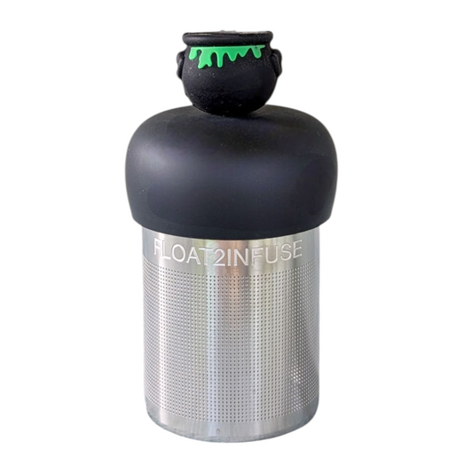 back view of a black cauldren with green ooze bubbling over tea infuser for loose leaf tea with a fine mesh stainless steel tea strainer that reads FLOAT2INFUSE on a black base with a white background