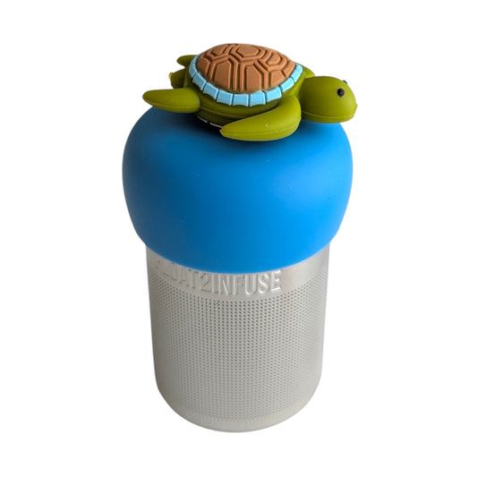 Side view of a cute green sea turtle with brown shell tea infuser for loose leaf tea with a fine mesh stainless steel tea strainer that reads FLOAT2INFUSE on a blue base with a white background