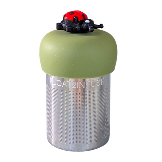 red and black ladybug tea infuser for loose leaf tea with fine mesh stainless steel tea strainer that reads FLOAT2INFUSE on a green base with white background