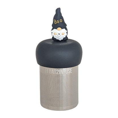 black gnome with a hat that reads "boo" holding a ghost tea infuser for loose leaf tea  with a fine mesh stainless steel tea infuser that reads FLOAT2INFUSE on a black base with a white background