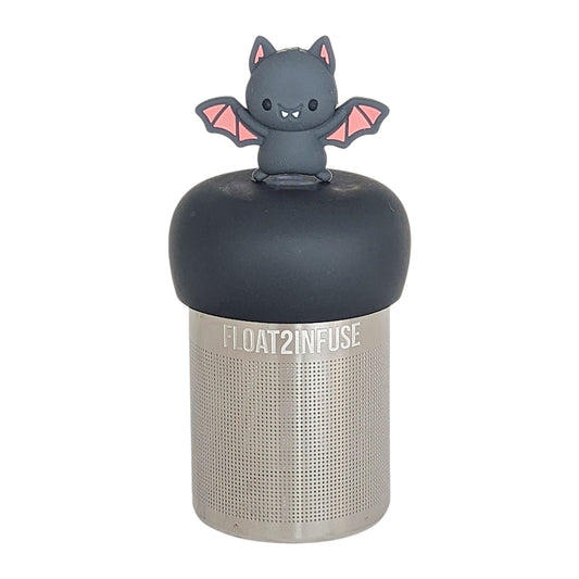 smiling grey and pink bat animal tea infuser for loose leaf tea  with a fine mesh stainless steel tea infuser that reads FLOAT2INFUSE on a black base with a white background