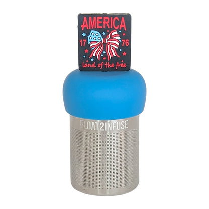 black square with text that reads "america land of the free 1776" that surrounds an american flag bow tea infuser for loose leaf tea  with a fine mesh stainless steel tea infuser that reads FLOAT2INFUSE on a blue base with a white background
