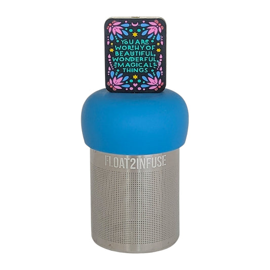 black rectangle with text that reads "you are worthy of beautiful wonderful magical things" tea infuser for loose leaf tea with a fine mesh stainless steel tea infuser that reads FLOAT2INFUSE on a blue base  on a white background