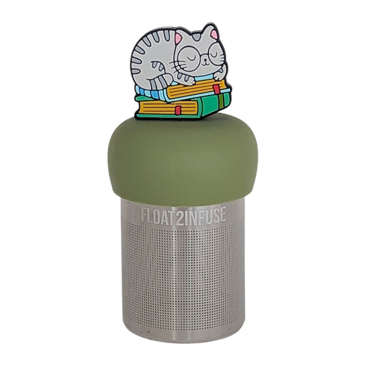 grey cat animal with glasses resting on a stack of green books tea infuser for loose leaf tea on a green base with a fine mesh stainless steel tea infuser that reads FLOAT2INFUSE on a white background