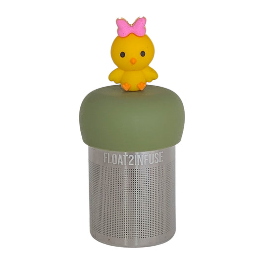 yellow chick animal with pink bow tea infuser for loose leaf tea  with a fine mesh stainless steel tea infuser that reads FLOAT2INFUSE on a green base with a white background