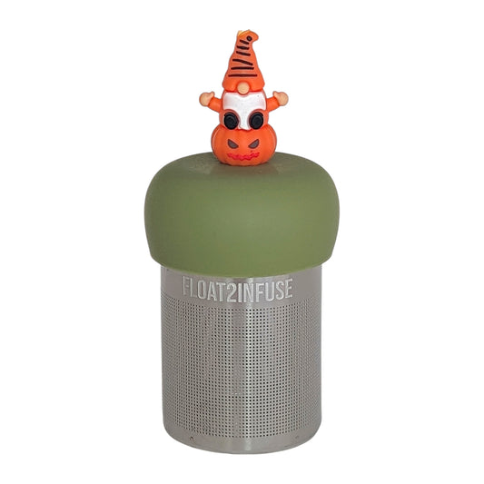 gnome sitting on a jack-o-lantern pumpkin tea infuser for loose leaf tea  with a fine mesh stainless steel tea infuser that reads FLOAT2INFUSE on a green base on a white background