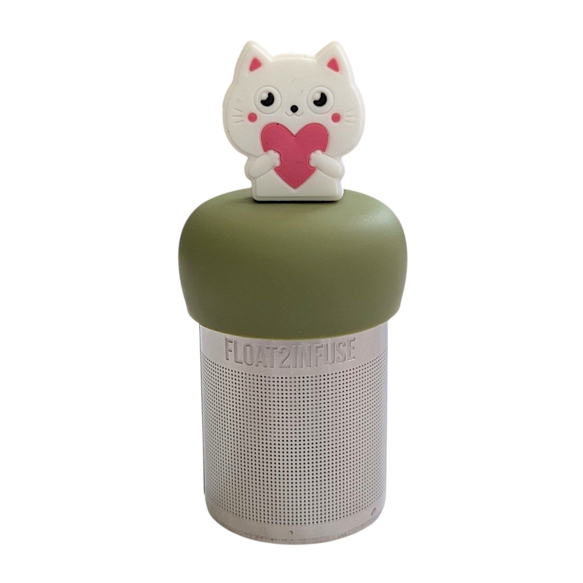 White cat holding a big pink heart tea infuser for loose leaf tea with a fine mesh stainless steel tea strainer that reads FLOAT2INFUSE on a green base with a white background