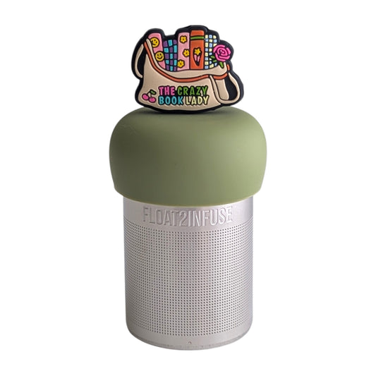 Beige bag with several brightly colored books sticking out the top and  the text "the crazy book lady" written on the bottom tea infuser for loose leaf tea with a fine mesh stainless steel tea strainer 
that reads FLOAT2INFUSE on a green base with a white background
