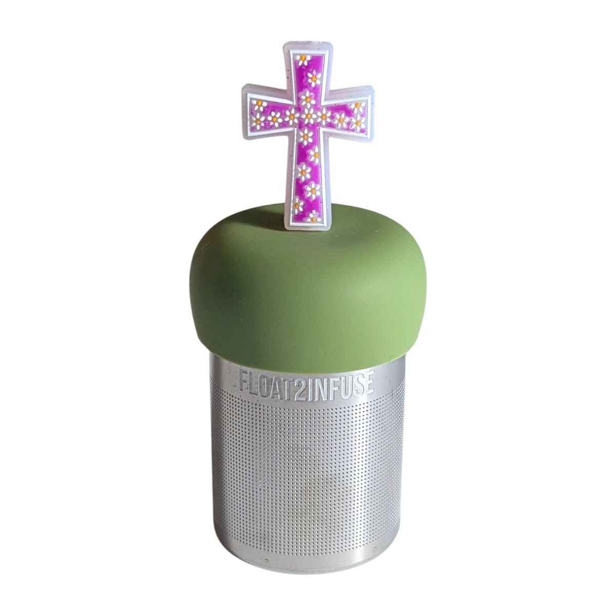 Purple cross with white polka dot daisies tea infuser for loose leaf tea with a fine mesh stainless steel tea strainer that reads FLOAT2INFUSE on a green base with a  white background
