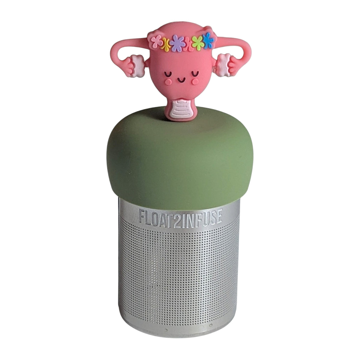 Pink Uterus with a smile and a floral crown tea infuser for loose leaf tea with a fine mesh stainless steel tea strainer that reads FLOAT2INFUSE on a green base with a  white background
