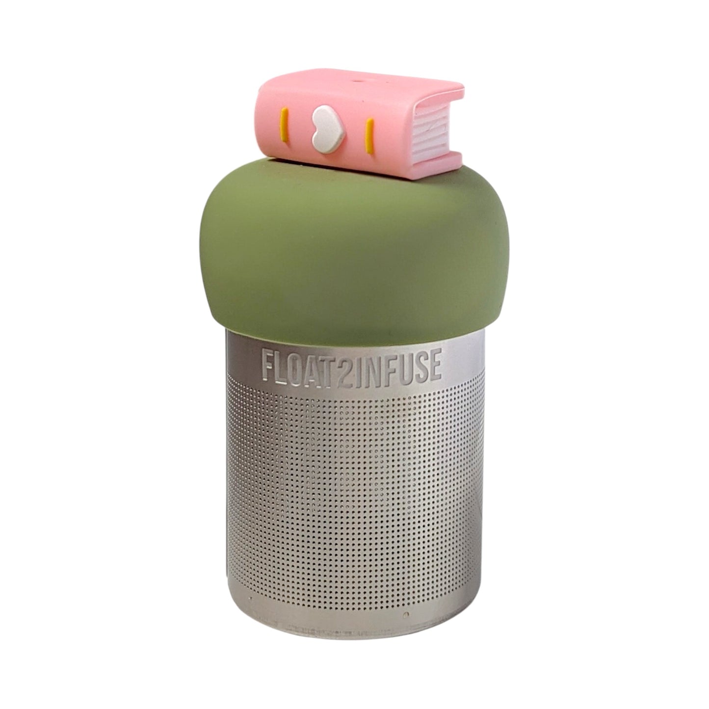 Light pink book with a white heart on the spine tea infuser for loose leaf tea with a fine mesh stainless steel tea strainer that reads FLOAT2INFUSE on a green base with a white background