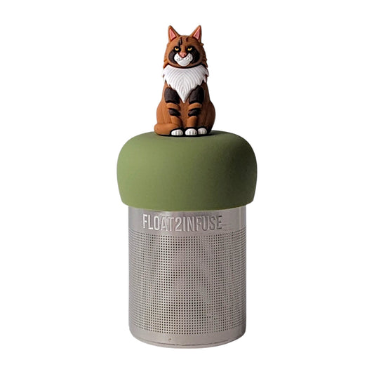 Brown, orange, and white Maine Coon cat  tea infuser for loose leaf tea with a fine mesh stainless steel tea strainer that reads FLOAT2INFUSE on a green base with a white background