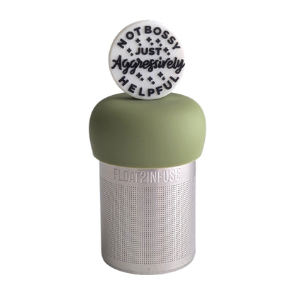White circle with black text that reads "not bossy just aggressively helpful" tea infuser for loose leaf tea with a fine mesh stainless steel tea strainer 
that reads FLOAT2INFUSE on a green base

