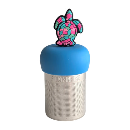 Sea Turtle with shades of pink, blue, and green in a mosaic pattern tea infuser for loose leaf tea with a fine mesh stainless steel tea strainer 
that reads FLOAT2INFUSE on a blue base with a white background
