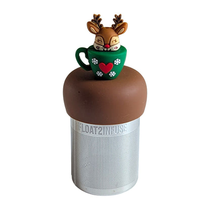 reindeer poking out of a green tea mug with snowflakes and heart decorations tea infuser for loose leaf tea  with a fine mesh stainless steel tea infuser that reads FLOAT2INFUSE on a brown base with a white background