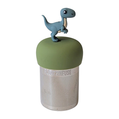 Cute smiling velociraptor dinosaur tea infuser for loose leaf tea with a fine mesh stainless steel tea strainer 
that reads FLOAT2INFUSE on a green base with a white background