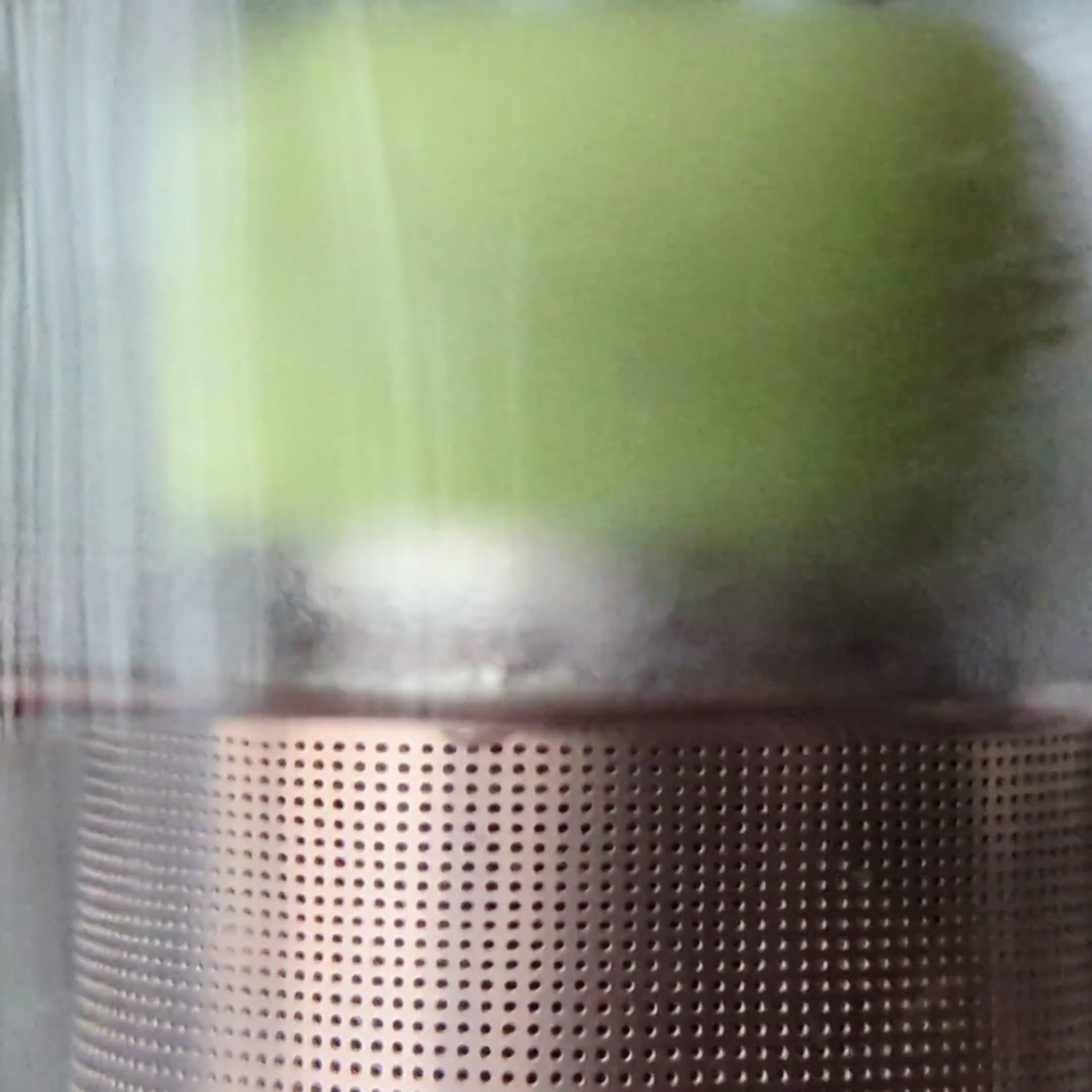 Load video: Floating Tea Steeper is sitting on the bottom of a glass mug. Hot water is added and the tea steeper immediately begins to float &amp; infuse the water with tea.