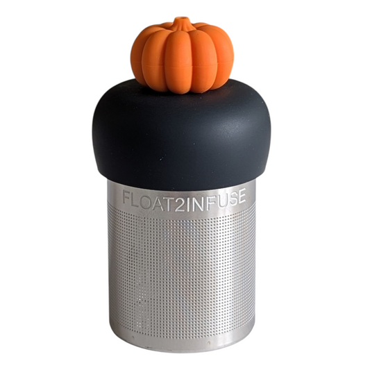 3d orange pumpkin tea infuser for loose leaf tea with a fine mesh stainless steel tea strainer that reads FLOAT2INFUSE on a black base with a white background