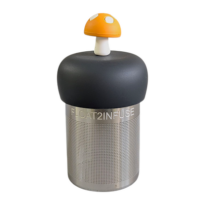 amber yellow mushroom tea infuser for loose leaf tea with a fine mesh stainless steel strainer that reads FLOAT2INFUSE on a black base with a white background