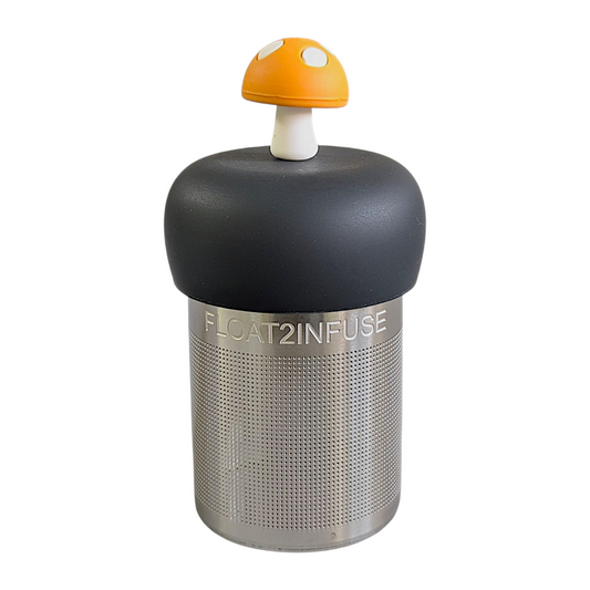 amber yellow mushroom tea infuser for loose leaf tea with a fine mesh stainless steel strainer that reads FLOAT2INFUSE on a black base with a white background
