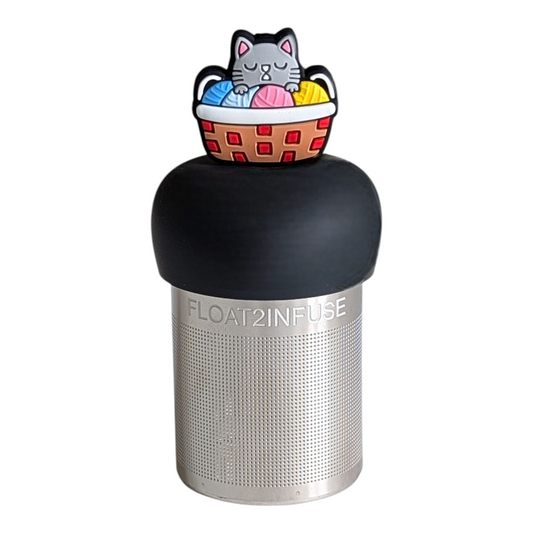 grey cat animal sleeping in a basket of yarn tea infuser for loose leaf tea with a fine mesh stainless steel tea strainer that reads FLOAT2INFUSE on a black base with a white background
