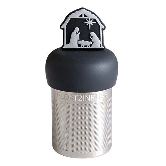 black and white nativity scene tea infuser for loose leaf tea with a fine mesh stainless steel tea strainer that reads FLOAT2INFUSE on a black base with a white background