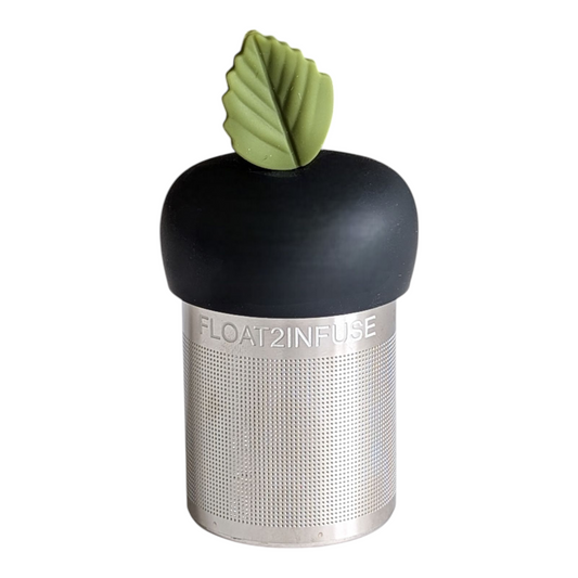 green herb leaf tea infuser for loose leaf tea with a fine mesh stainless steel tea strainer that reads FLOAT2INFUSE on a black base with a white background