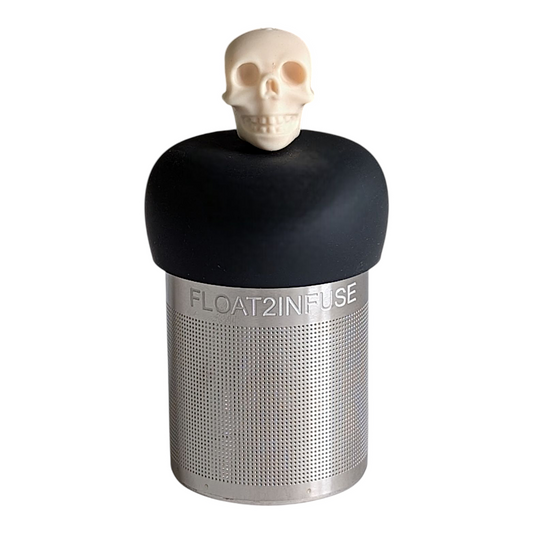 ivory skull tea infuser for loose leaf tea with a fine mesh stainless steel tea strainer that reads FLOAT2INFUSE on a black base with a white background