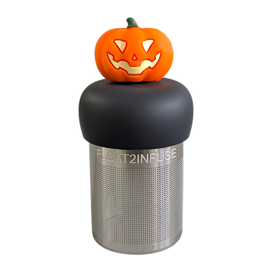 orange jack-o-lantern tea infuser for loose leaf tea  with a fine mesh stainless steel strainer that reads FLOAT2INFUSE on a black base with a white background