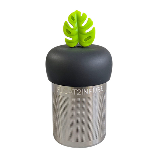 lime green monstera leaf tea infuser for loose leaf tea with a fine mesh stainless steel strainer that reads FLOAT2INFUSE on a black base with a white background