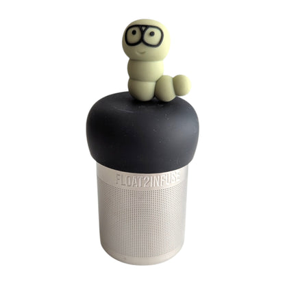 Light green caterpillar with black rim glasses infuser for loose leaf tea  with a fine mesh stainless steel tea infuser that reads FLOAT2INFUSE on a green base with a white background