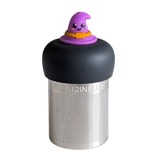 purple witch hat with a smiling face and an orange buckle tea infuser for loose leaf tea with a fine mesh stainless steel tea strainer that reads FLOAT2INFUSE on a black base with a white background