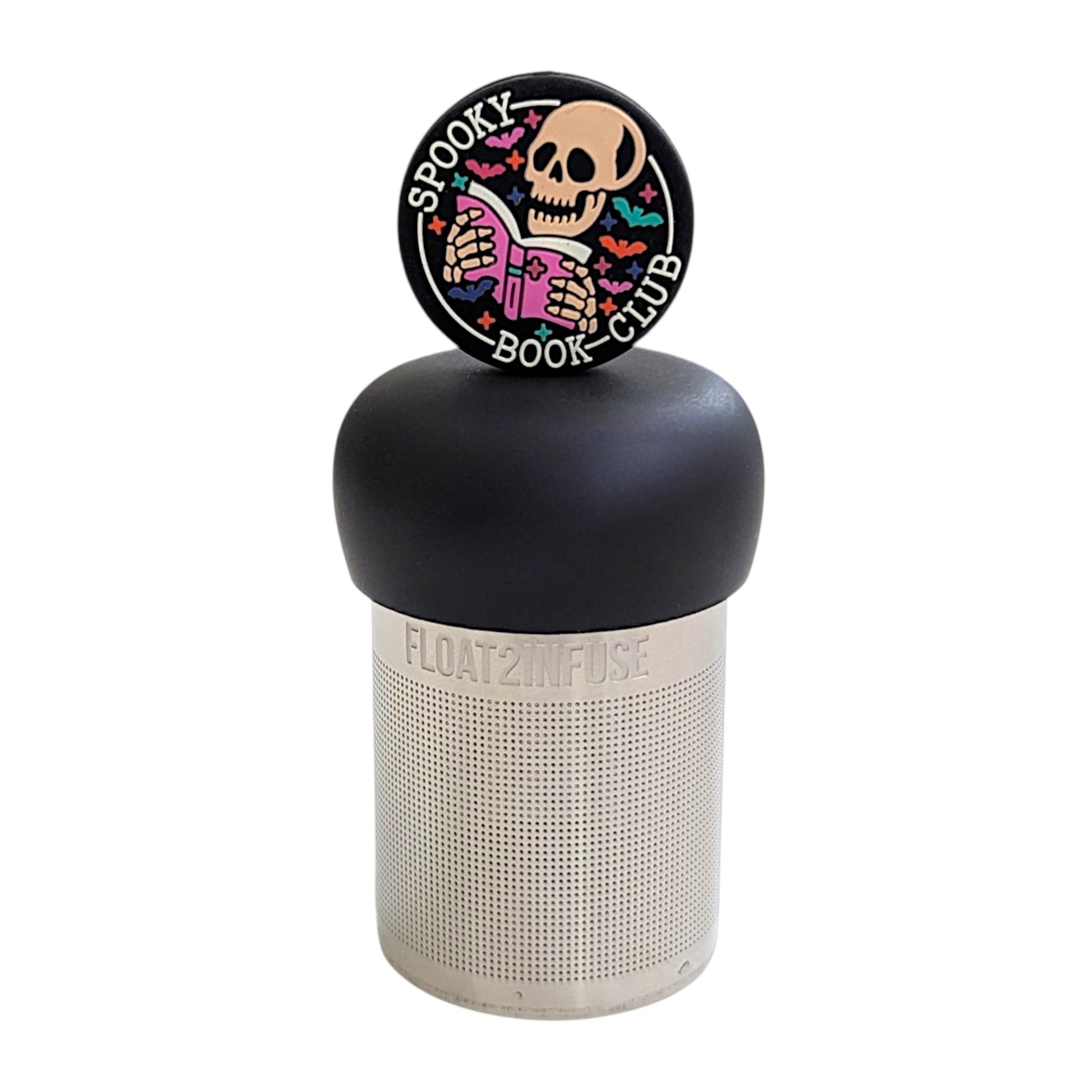 Black circle with an ivory skeleton reading a pink book with the text "spooky book club" and multicolored bats circling it tea infuser for loose leaf tea with a fine mesh stainless steel tea strainer that reads FLOAT2INFUSE on a black base with a white background
