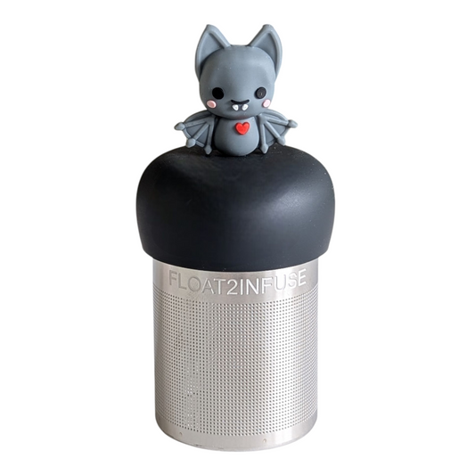 blushing grey vampire bat with red heart tea infuser for loose leaf tea with a fine mesh stainless steel tea strainer that reads FLOAT2INFUSE on a black base with a white background
