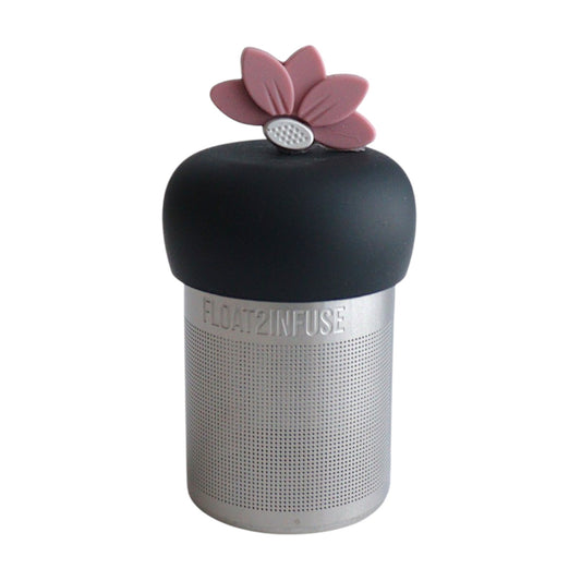 warm pink lotus flower tea infuser for loose leaf tea  with a fine mesh stainless steel tea infuser that reads FLOAT2INFUSE on a black base with a white background