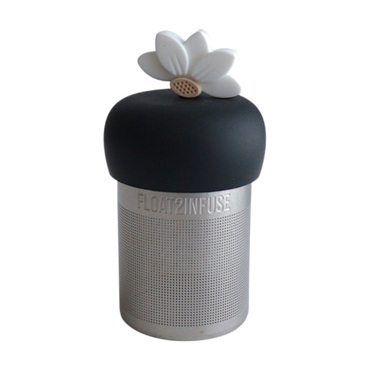 white lotus flower tea infuser for loose leaf tea  with a fine mesh stainless steel tea infuser that reads FLOAT2INFUSE on a black base with a white background