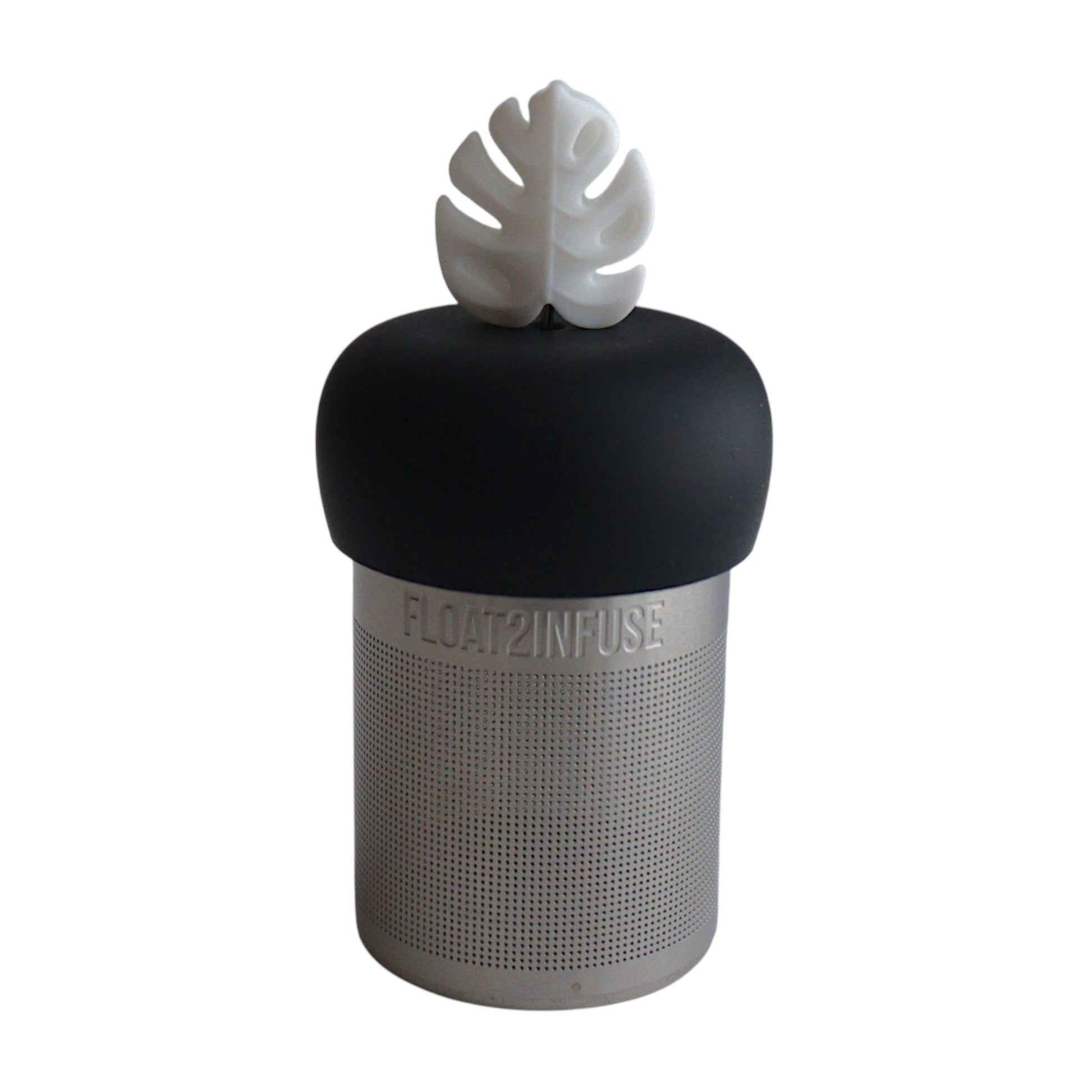 white monstera leaf tea infuser for loose leaf tea with a fine mesh stainless steel tea strainer 
that reads FLOAT2INFUSE on a green base with a white background