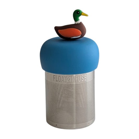 Mallard duck animal tea infuser for loose leaf tea on a blue base with a fine mesh stainless steel tea strainer that reads FLOAT2INFUSE with a white background