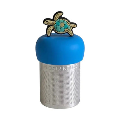 A sea turtle with a geometric shell pattern standing on its fins tea infuser for loose leaf tea with a fine mesh stainless steel tea strainer that reads FLOAT2INFUSE on a blue base with a white background