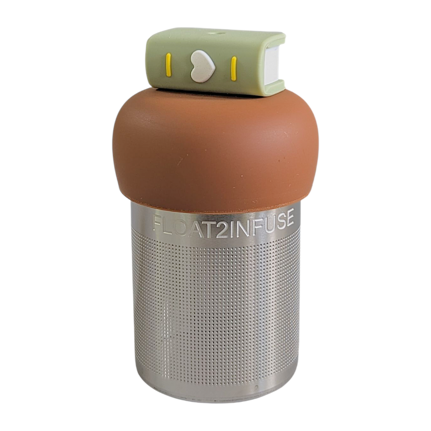 green book with a white heart on the spine tea infuser for loose leaf tea with fine mesh stainless steel tea strainer that reads FLOAT2INFUSE on a brown base with a white background