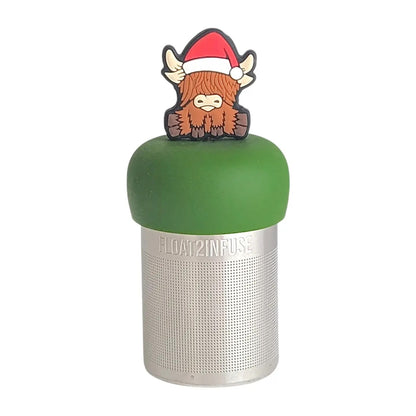Brown highland cow wearing a santa hat a  tea infuser for loose leaf tea with a fine mesh stainless steel tea strainer  that reads FLOAT2INFUSE on a dark green base with a white background