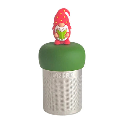 gnome with a long white beard wearing red with yellow polka dots on the hat singing Christmas carols from a green songbook tea infuser for loose leaf tea with a fine mesh stainless steel tea strainer that reads FLOAT2INFUSE on a dark green base with a white background