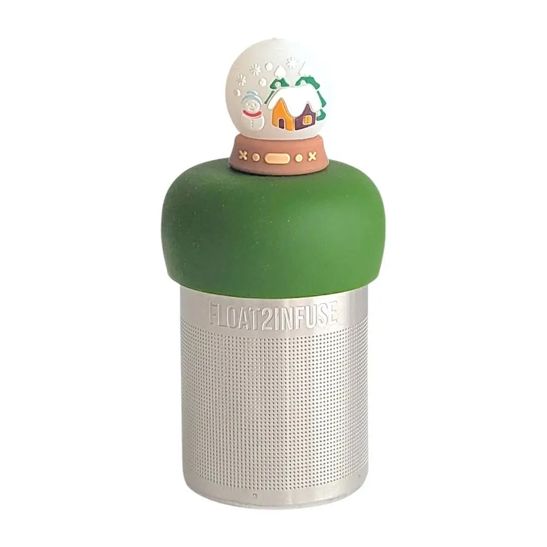 back view of a snowglobe with a snowman and a cabin inside for loose leaf tea with fine mesh stainless steel tea strainer that reads FLOAT2INFUSE on a dark green base with a white background