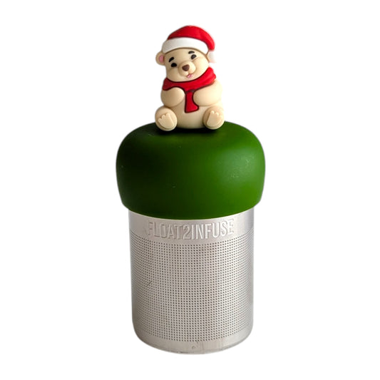 Cozy white polar bear wearing a red and white santa hat and a red scarf tea infuser for loose leaf tea with a fine mesh stainless steel tea strainer 
that reads FLOAT2INFUSE on a dark green base with a white background

