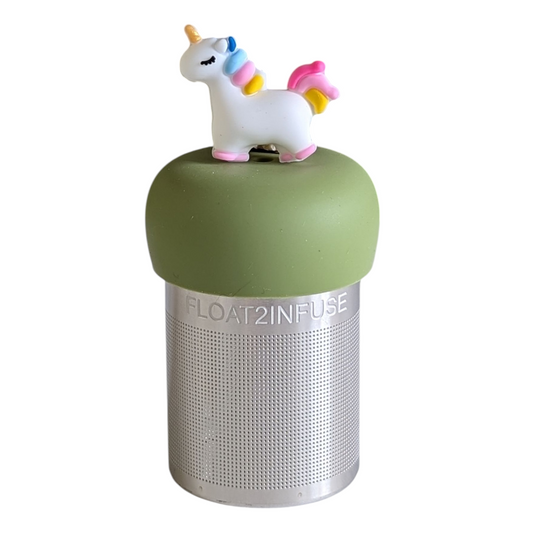 3d white unicorn with a rainbow mane and gold horn tea infuser for loose leaf tea on a green base with a fine mesh stainless steel strainer that reads FLOAT2INFUSE with a white background