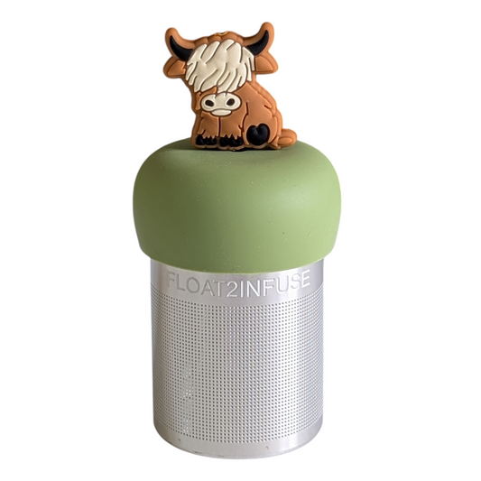 adult brown highland cow animal tea infuser for loose leaf tea with a fine mesh stainless steel tea strainer that reads FLOAT2INFUSE on a green base with a white background