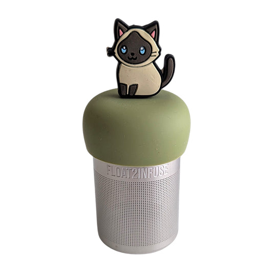 Anime siamese cat with blue eyes tea infuser for loose leaf tea  with a fine mesh stainless steel tea infuser that reads FLOAT2INFUSE on a green base with a white background