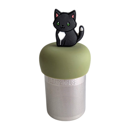 Anime black cat with white belly and white-tipped tail tea infuser for loose leaf tea  with a fine mesh stainless steel tea infuser that reads FLOAT2INFUSE on a green base with a white background