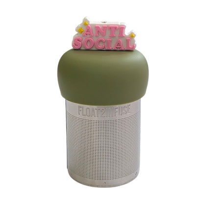 Pink text reads "antisocial" with yellow stars and white outline tea infuser for loose leaf tea with a fine mesh stainless steel tea strainer that reads FLOAT2INFUSE on a green base with a white background