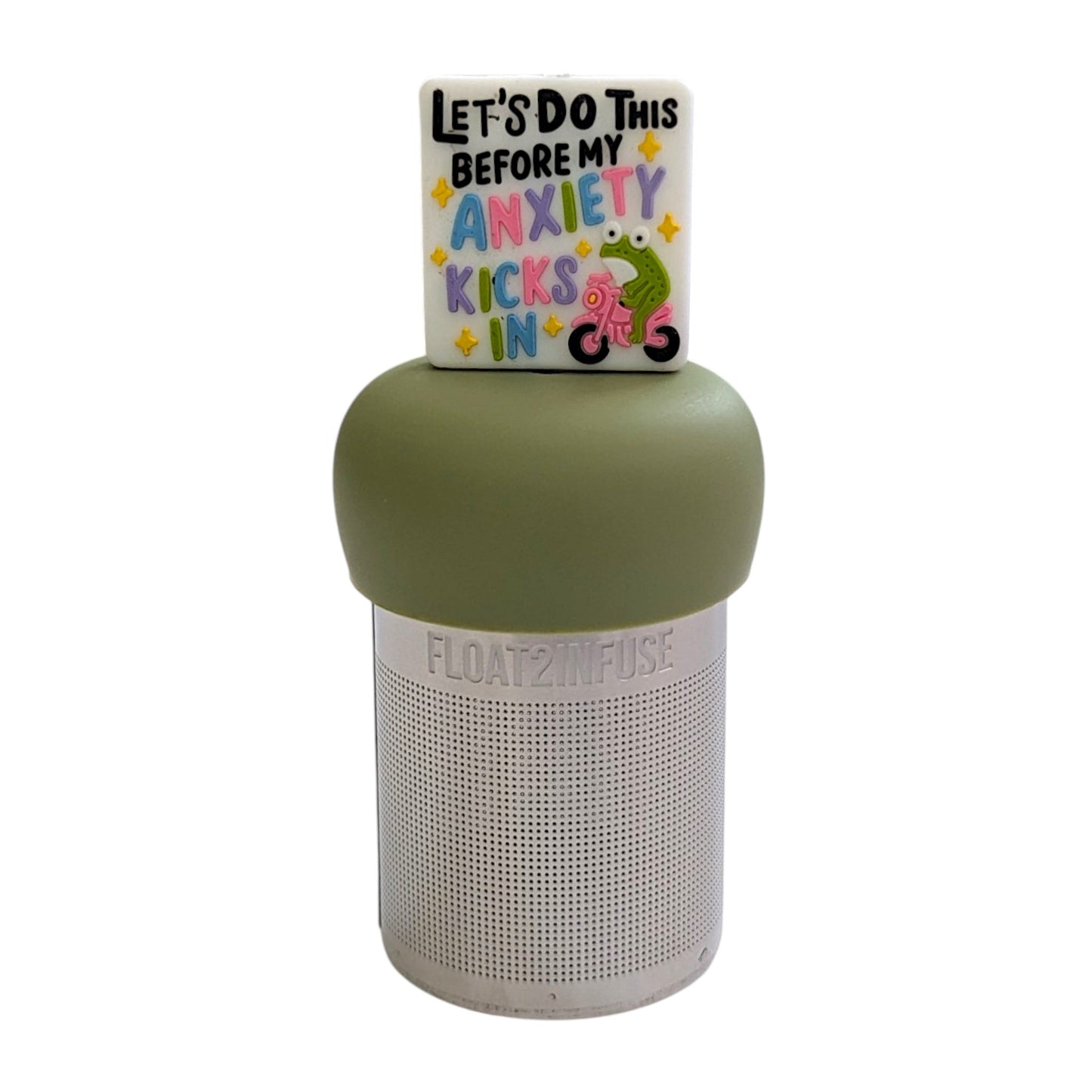 White square with text "let's do this before my anxiety kicks in" with a green frog riding a pink bike tea infuser for loose leaf tea with a fine mesh stainless steel tea strainer that reads FLOAT2INFUSE on a green base with a white background